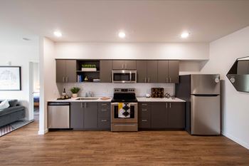 Fuel up—modern kitchens with full-size stainless-steel appliances, quartz countertops and soft close cabinets